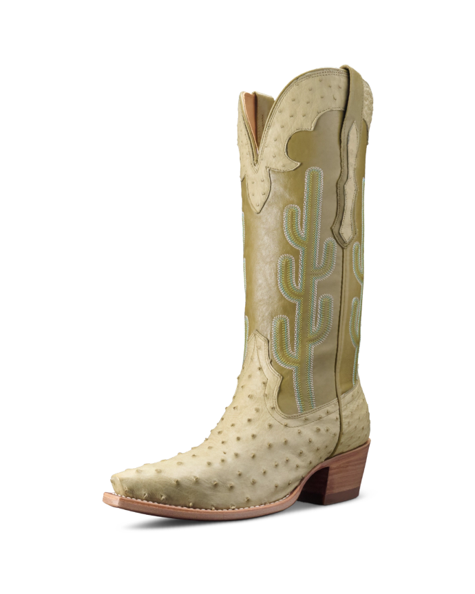 A tan cowboy boot with a pointed toe, ostrich skin texture, and cactus embroidery on the side, set against a black background.