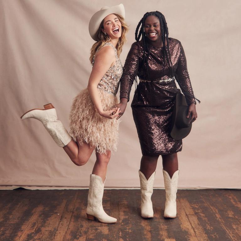 two women in Cowboy boots, posing