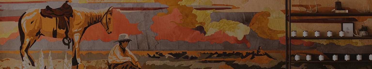 A mural depicts a person in a hat sitting beside a saddled horse in a desert landscape, with shelves of candles on the right.