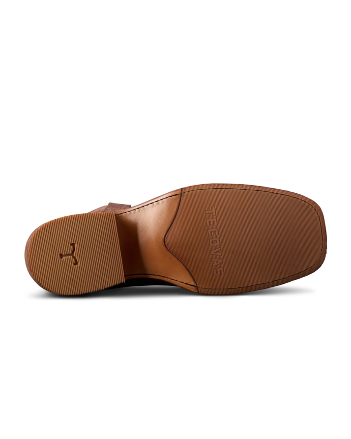 Bottom view of a brown leather shoe sole with textured grip and the brand name "Meermin" embossed.