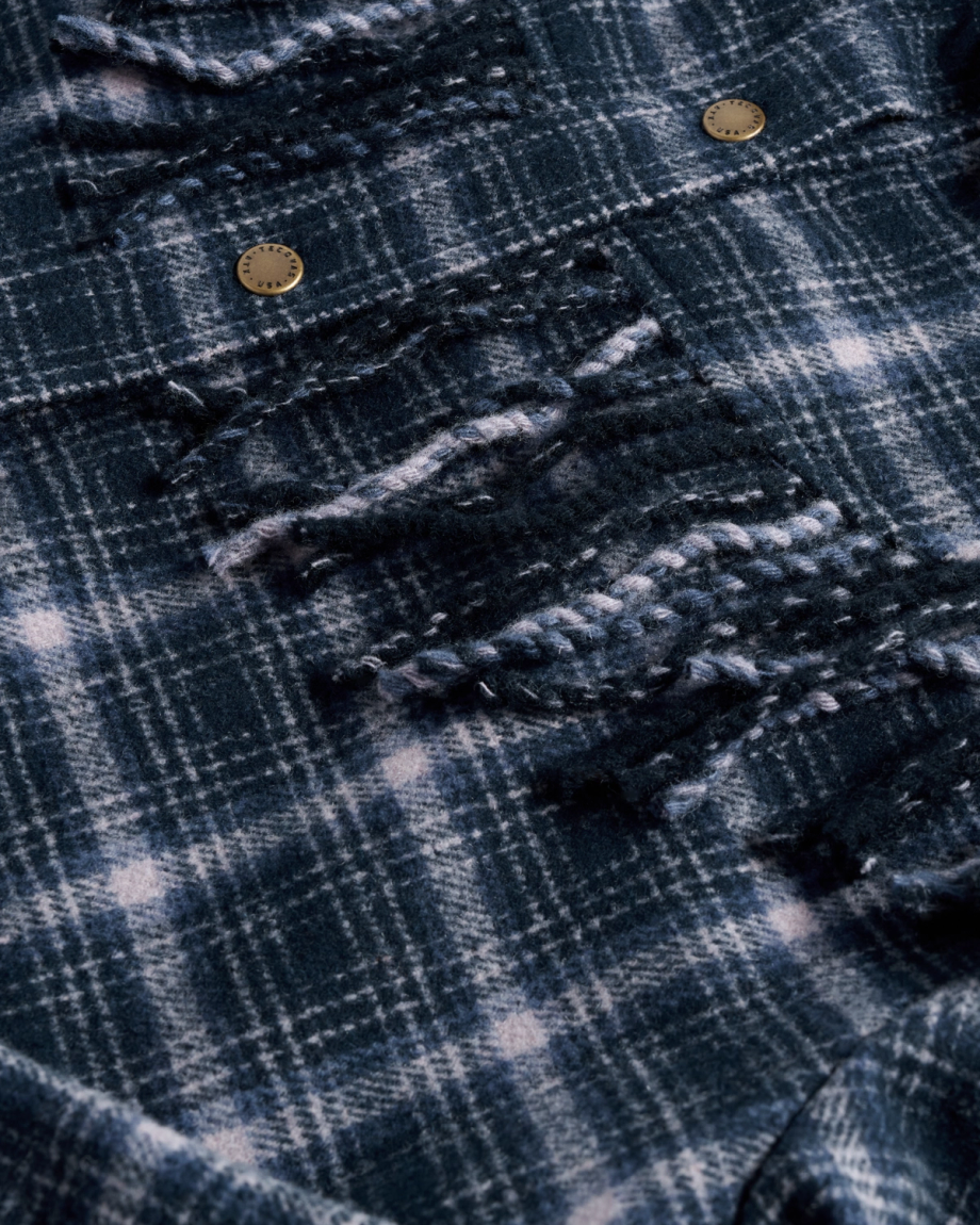 Closeup detail view of Women's Plaid Fringe Shacket - Navy / Mauve