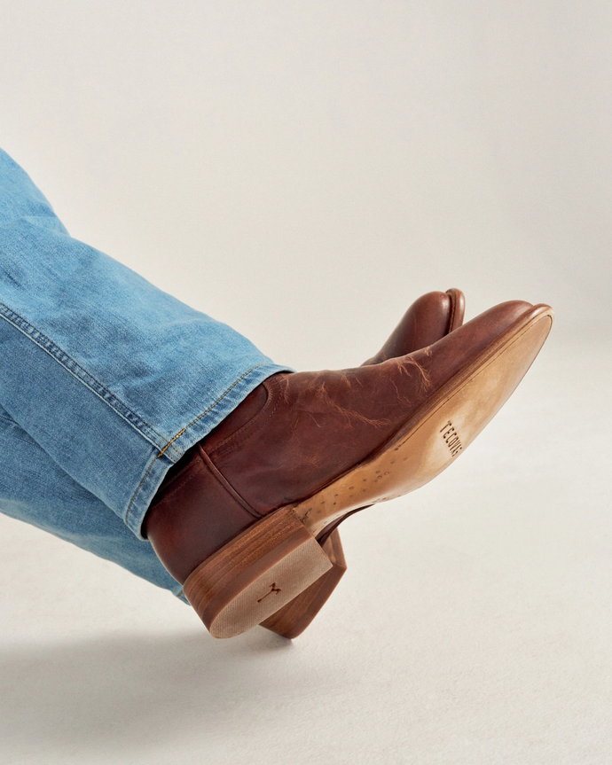 close up picture of Earl scotch brown cowboy boots on a man's feet