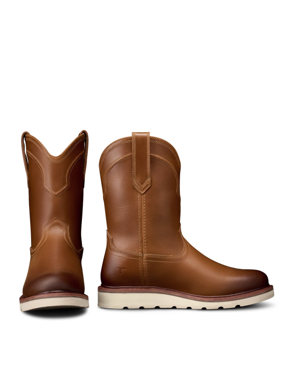 The Knox in Wheat Cowhide. A pair of The Knox Cowhide brown leather pull-on boots with white soles, one boot facing forward and the other angled to show the side profile.