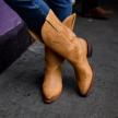 woman in in vintage tan cowgirl boots