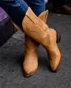 woman in in vintage tan cowgirl boots