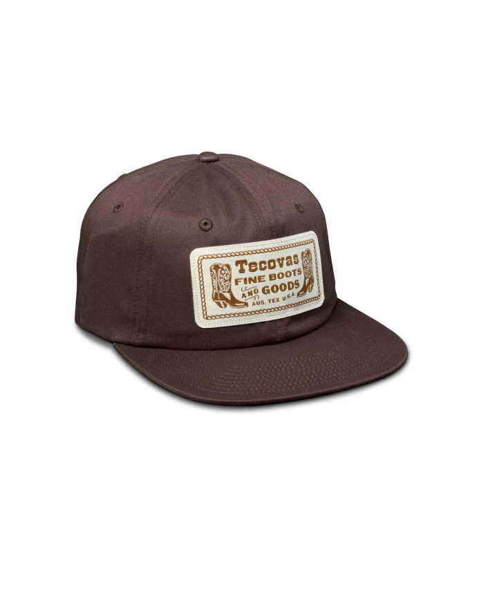 Quarterfront view of Fine Boots Flat Brim Hat - Brown on plain background