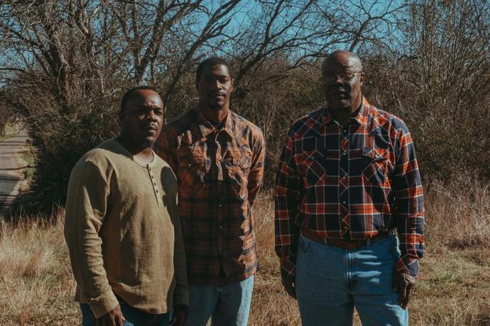 three men in a field