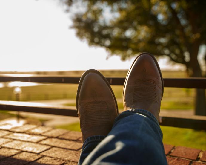 Pair of boots resting on railing 