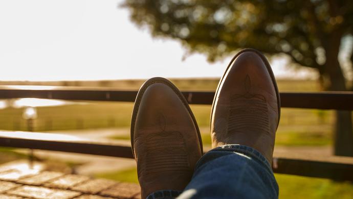 Pair of boots resting on railing