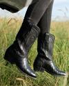 Woman in midnight black cowgirl boots
