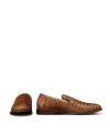 The Bennett in Saddle Alligator. A pair of brown alligator-leather loafers. One shoe shown from the side and one from the front on a white background.