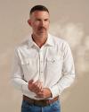 Man wearing a white pearl snap in a photo studio