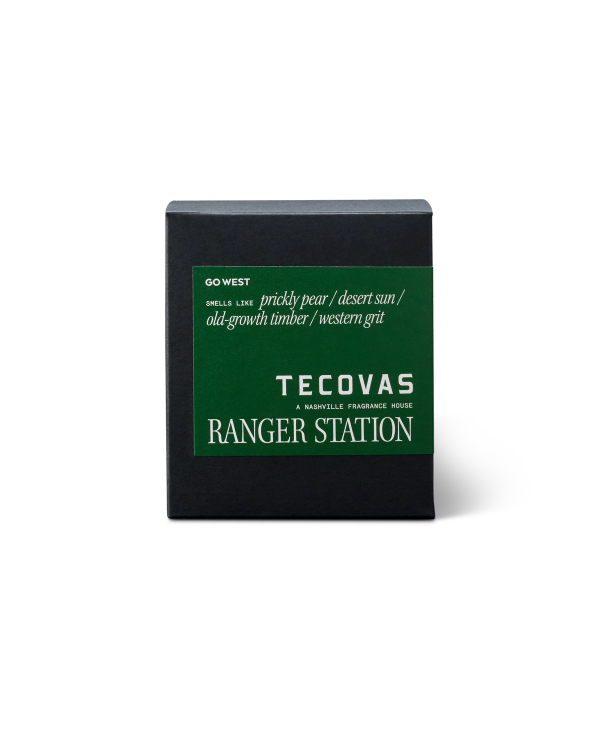 Black box with a green label, featuring the text: "Go West," "smells like prickly pear / desert sun / old-growth timber / western grit," and "Tecovas Ranger Station.