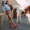 woman wearing shorts and cowgirl boots