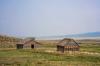 two small cabins in a field