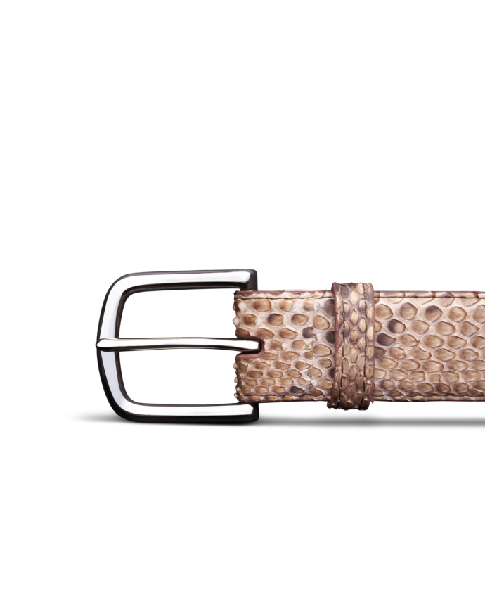 Close-up of a brown textured belt with a silver buckle against a black background.