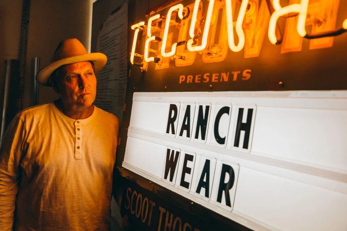 Todd Sanders standing in front of Tecovas neon sign