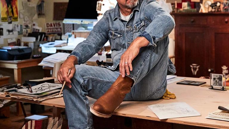 Image of Jon Flaming: Artist sitting on a table | Tecovas
