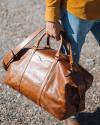A person holding Bartlett Large Weekender in Cognac