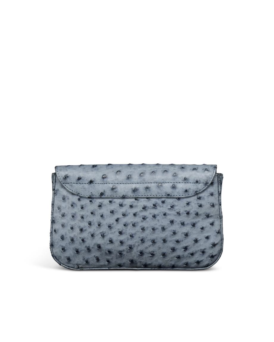 A gray ostrich leather clutch bag with a flap closure, displayed against a plain white background.
