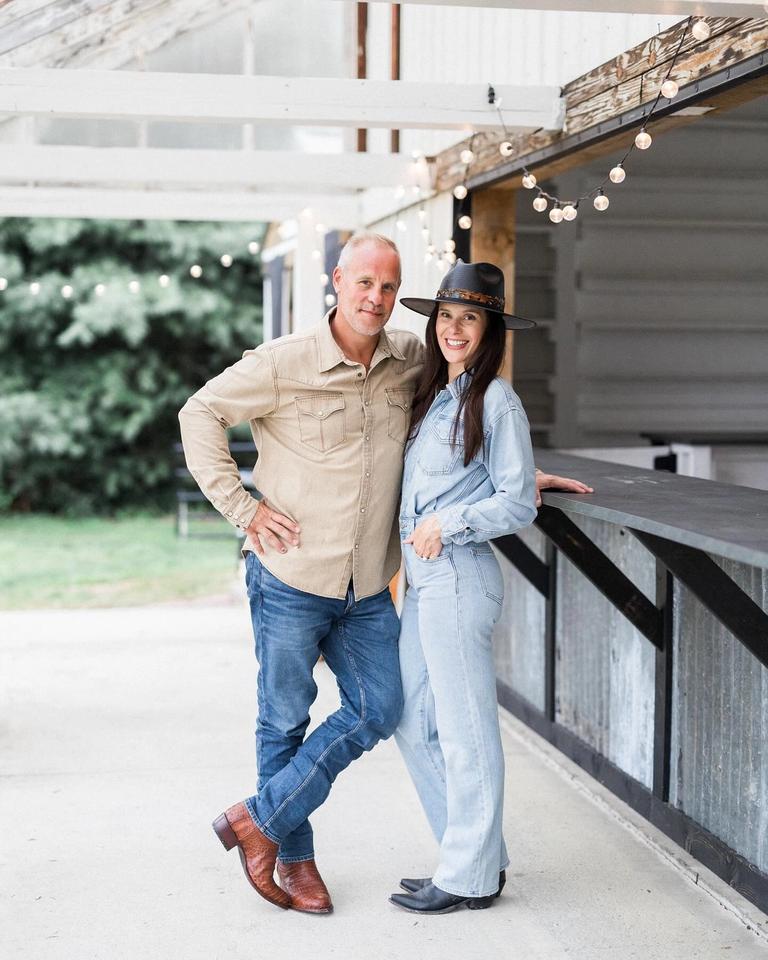 Couple standing at an outdoor venue wearing denim outfits