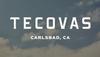 Text reads "Tecovas Carlsbad, CA" in bold white letters against a sky background with scattered clouds.