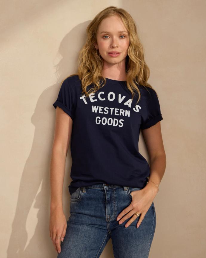 Woman wearing the Navy Tecovas Western Goods t shirt. 