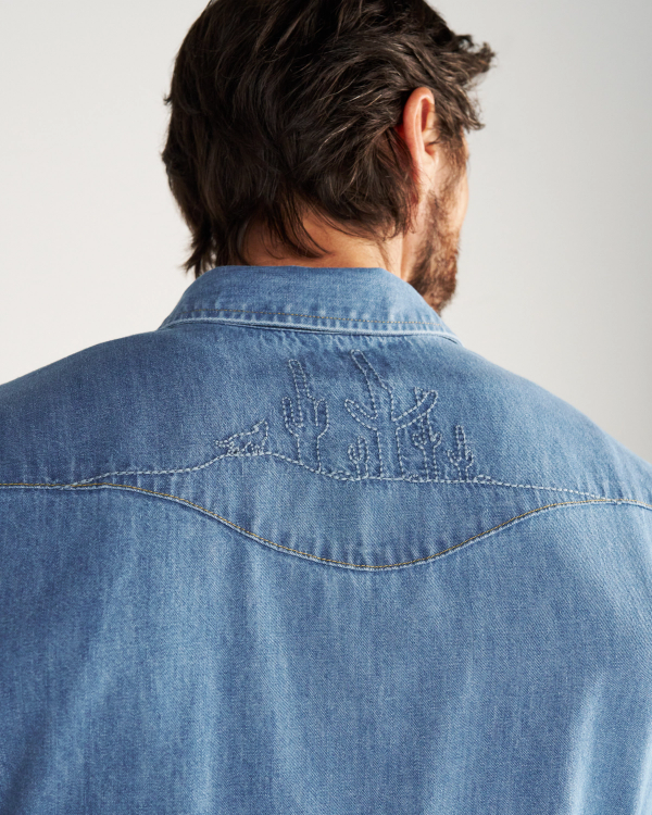 Closeup detail view of Men's Denim Pearl Snap SS - Turquoise / Multi