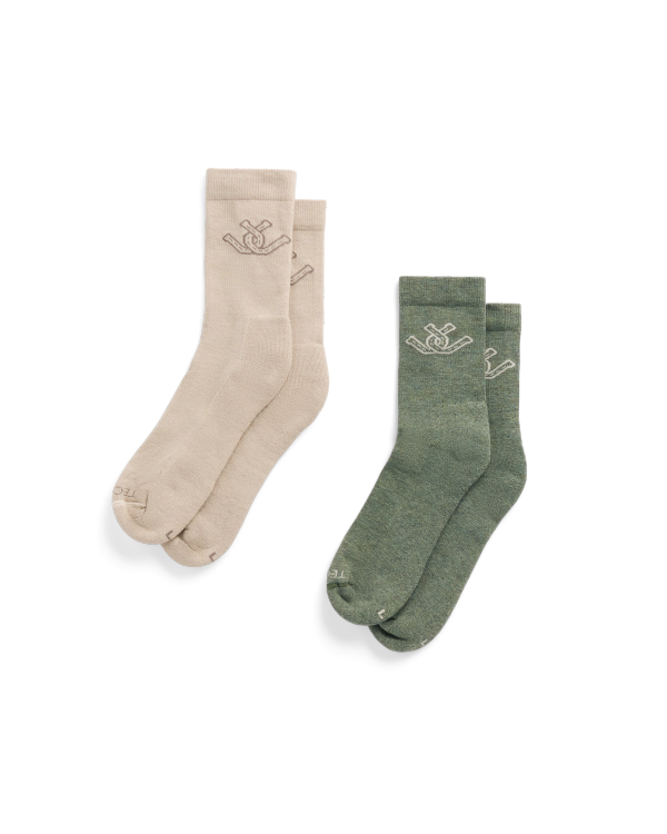 Two pairs of crew socks, one beige and one green, each with a small embroidered logo near the top.
