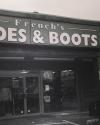 Storefront sign reads "French's SHOES & BOOTS"; entrance with glass doors and display mannequins visible inside.