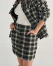 Front view of Women's Plaid Mini Skirt - Black / White on model