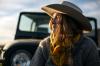 woman in a cowgirl hat and scarf