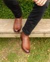 close up picture of Cartwright Bourbon brown cowboy boots on a man's feet