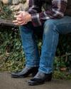 close up picture of Dillon Midnight black cowboy boots on a man's feet
