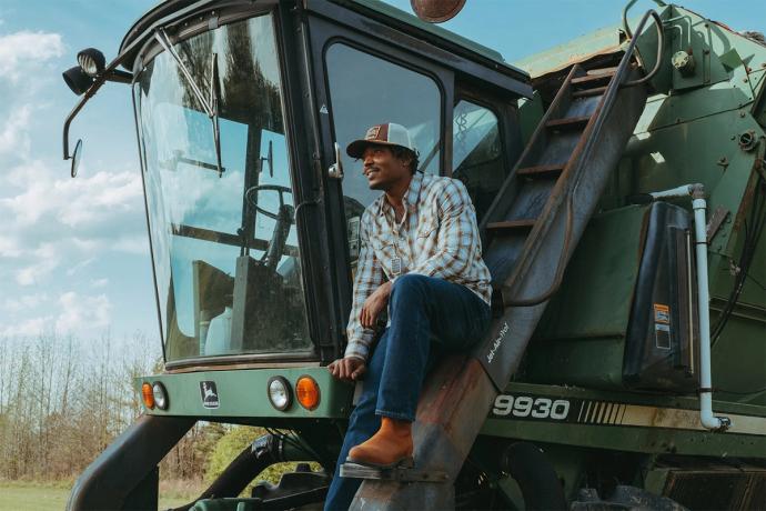 man on farm equipment