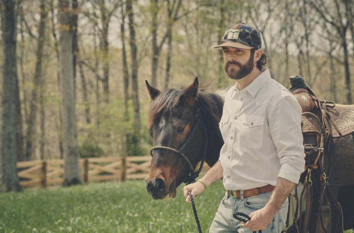 Thomas Rhett leading a horse