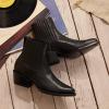 Black chelsea boots on wood floor