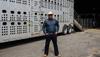 Man standing outside of a cattle truck
