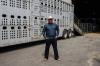 Man standing outside of a cattle truck