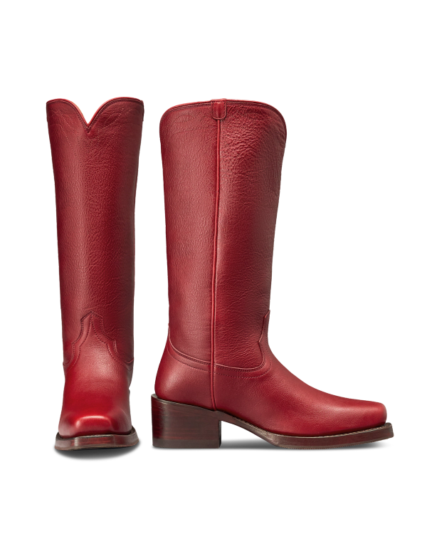 The Charlie in Scarlet Cowhide. Pair of tall, scarlet cowhide leather boots with block heels and a square toe, shown front and side view against a white background.