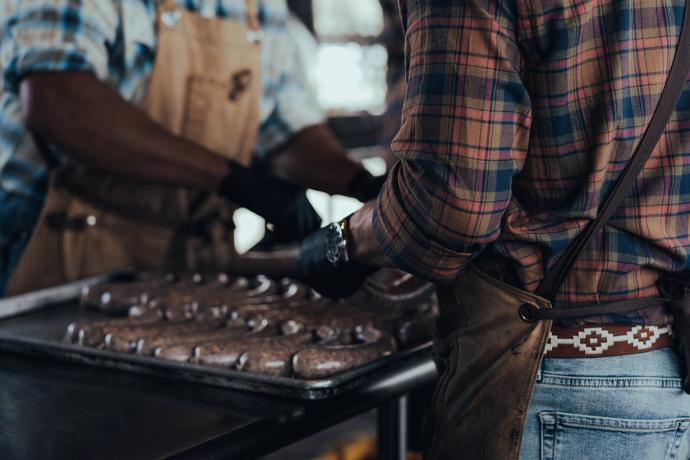 men cooking sausage