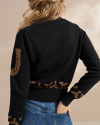 Back view of Women's Crew Neck Lucky Boots Sweater - Black Heather/Oatmeal on model