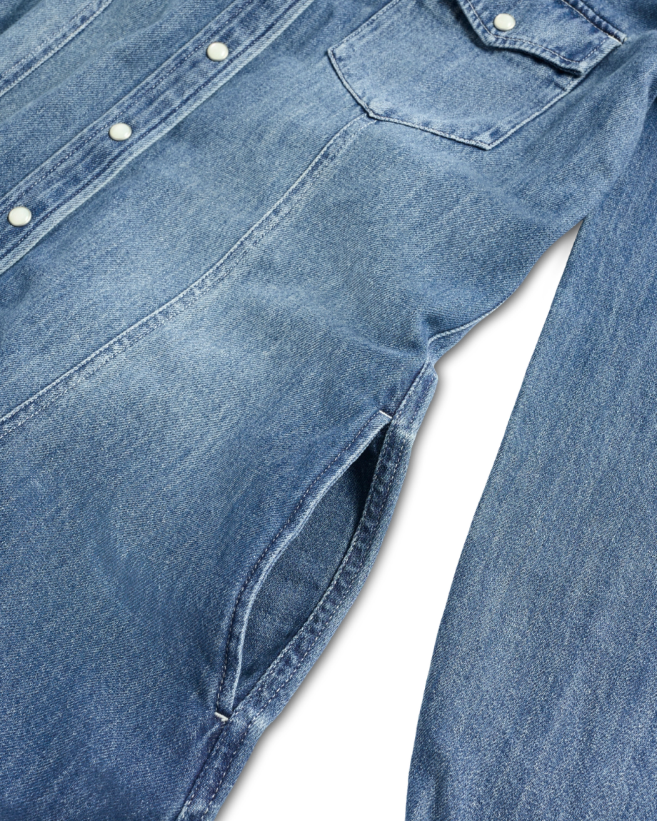 Light blue denim shirt with snap buttons, a chest pocket, and side slit pockets.
