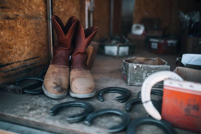 pair of boots next to horseshoes