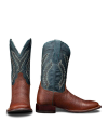 The Doc in Burnt Umber / Blue Cowhide. A pair of cowboy boots with burnt umber cowhide foot and heel, and a blue shaft featuring white decorative stitching. One boot is shown from the front, the other from the side.