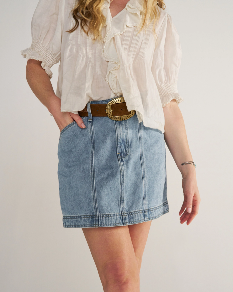 Front view of Women's High-Rise Denim Mini Skirt - Light Wash on model