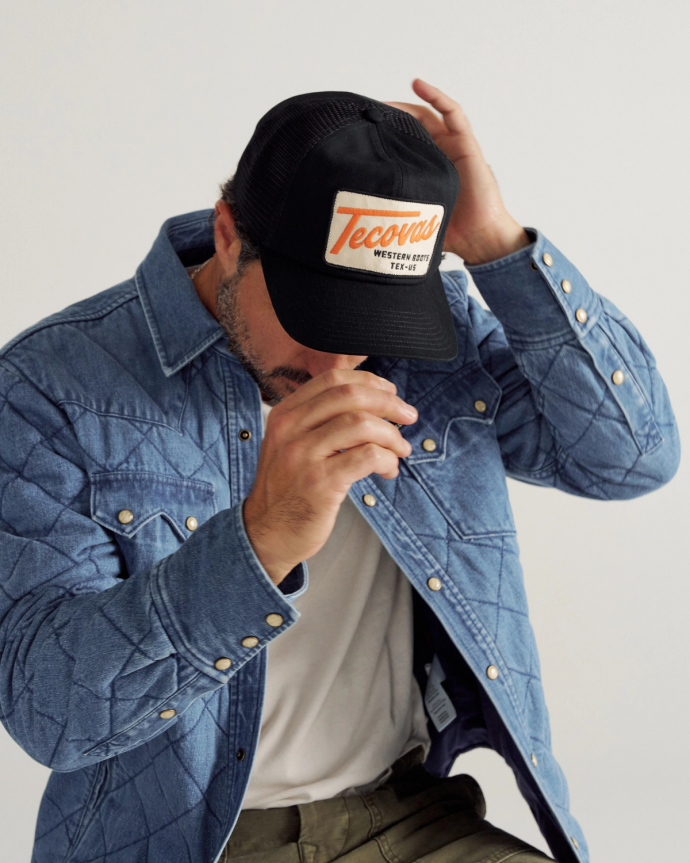 Front view of Tecovas Patch Flat Brim 6 Panel Trucker - Black on plain background