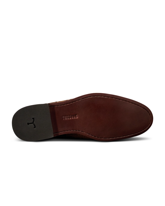 The Bennett in Saddle Alligator. The image shows the brown leather sole of a Saddle Alligator dress shoe with the word "STACY" embossed near the arch and a textured grey heel.