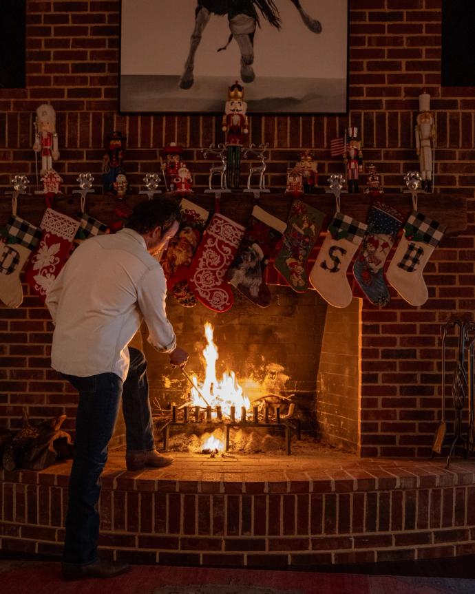 Man standing in front of a fireplace.