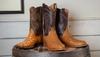 Three different styles of ostrich boots on display
